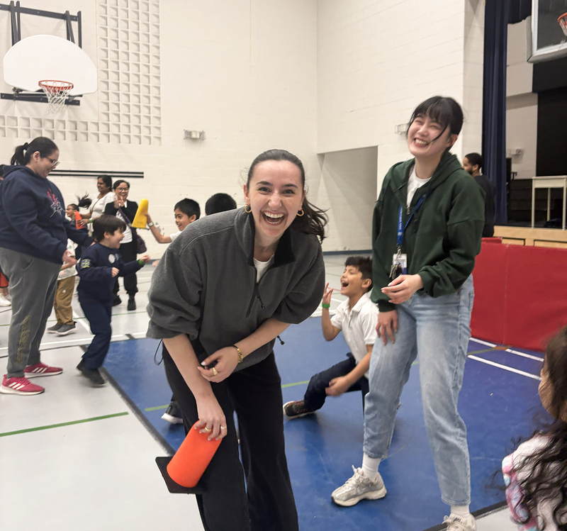Photo of students, staff, and community members enjoying games in the school gym