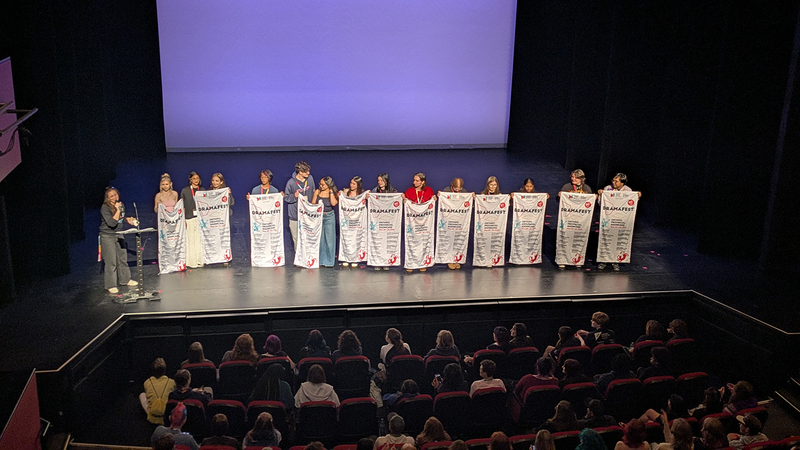 Group photo of the student performers on stage