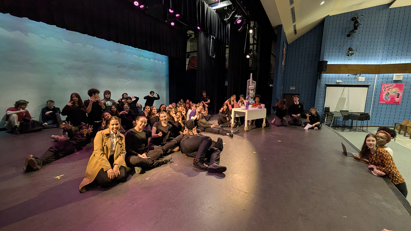 Group photo of the student performers on stage
