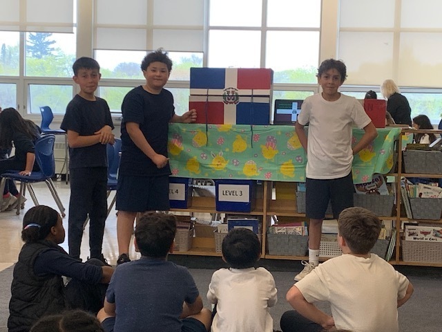 Photo of students presenting the display they created