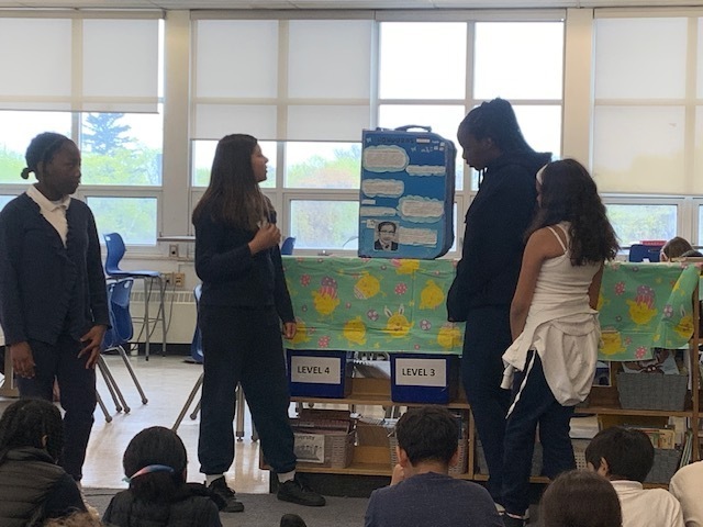 Photo of students presenting the display they created
