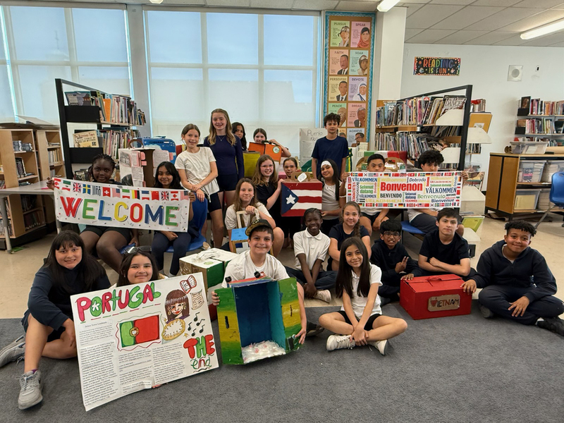 Group photo of St. Benedict students with the displays they created