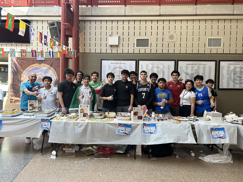 Photos of cultural food table set up by Brebeuf students, showcasing food from the cultural region and countries from that culture and region