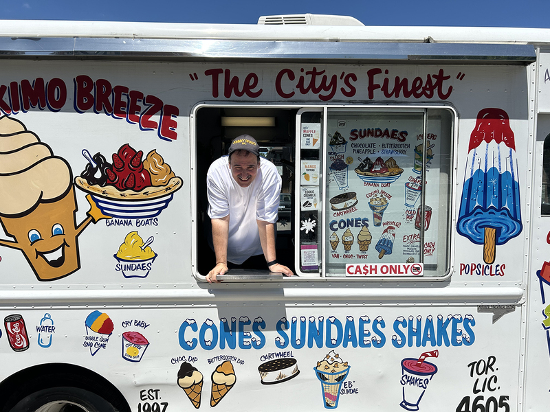 Photo of the ice cream vendor posing with his truck