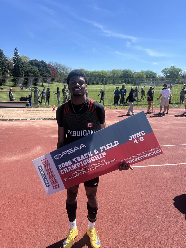 Photo of JCM athlete on the field holding up OFSAA ticket