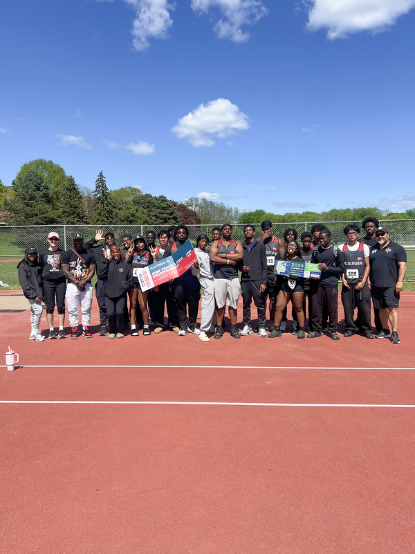 Group photo of JCM students and teachers on the field