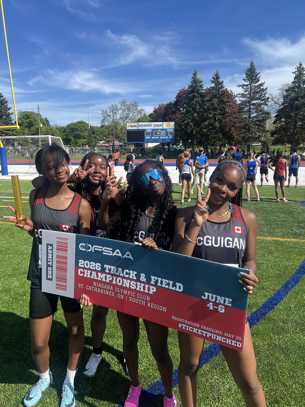 Photo of JCM athletes on the field holding up OFSAA ticket