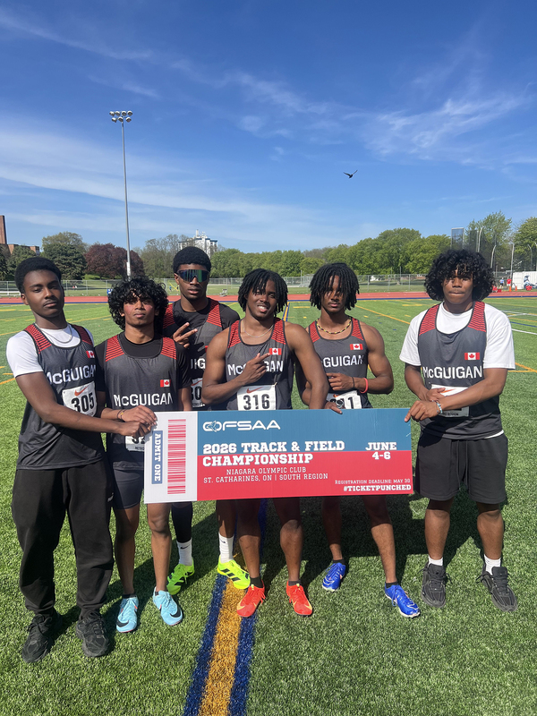 Photo of JCM athletes on the field holding up OFSAA ticket