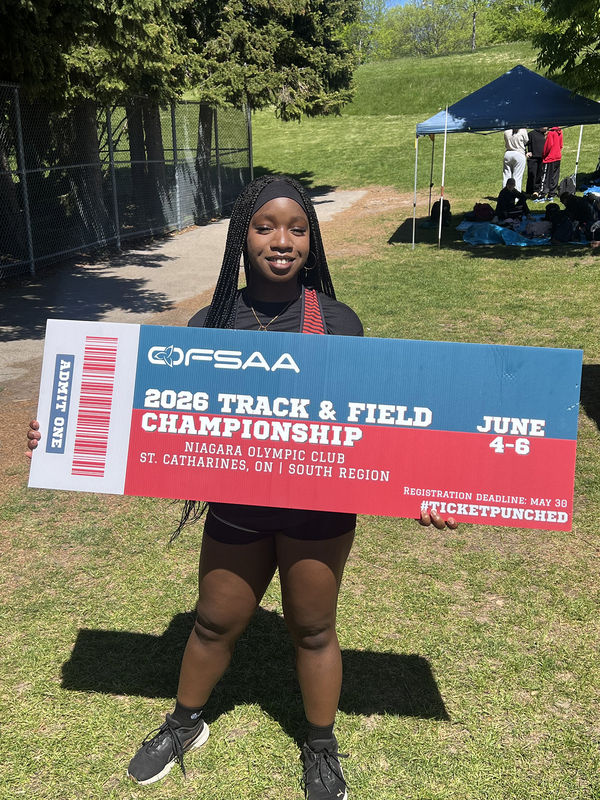 Photo of JCM athlete on the field holding up OFSAA ticket