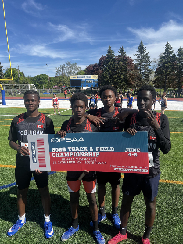 Photo of JCM athletes on the field holding up OFSAA ticket