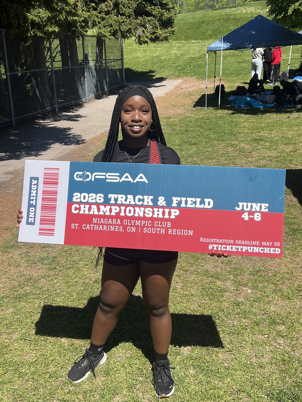 Photo of JCM athlete on the field holding up OFSAA ticket