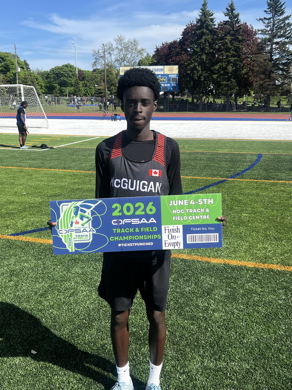 Photo of JCM athlete on the field holding up OFSAA ticket