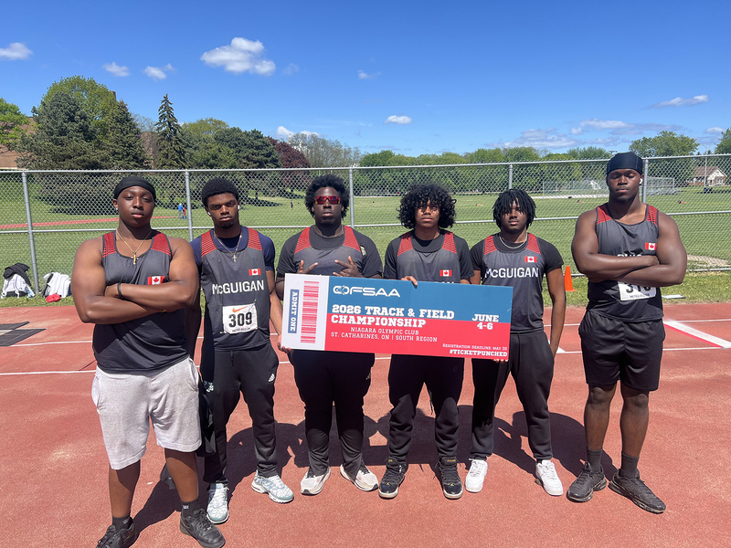 Photo of JCM athletes on the field holding up OFSAA ticket