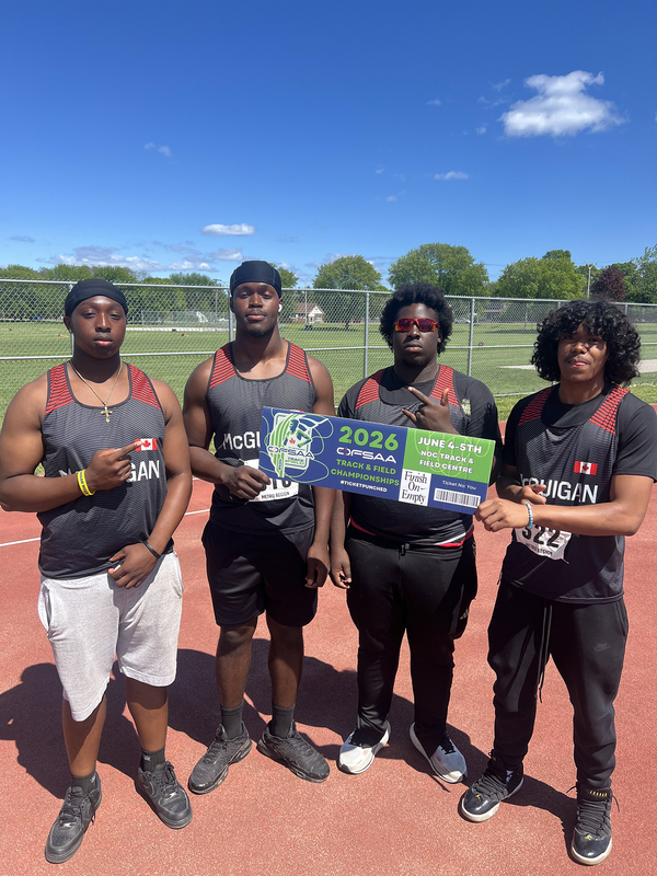 Photo of JCM athletes on the field holding up OFSAA ticket