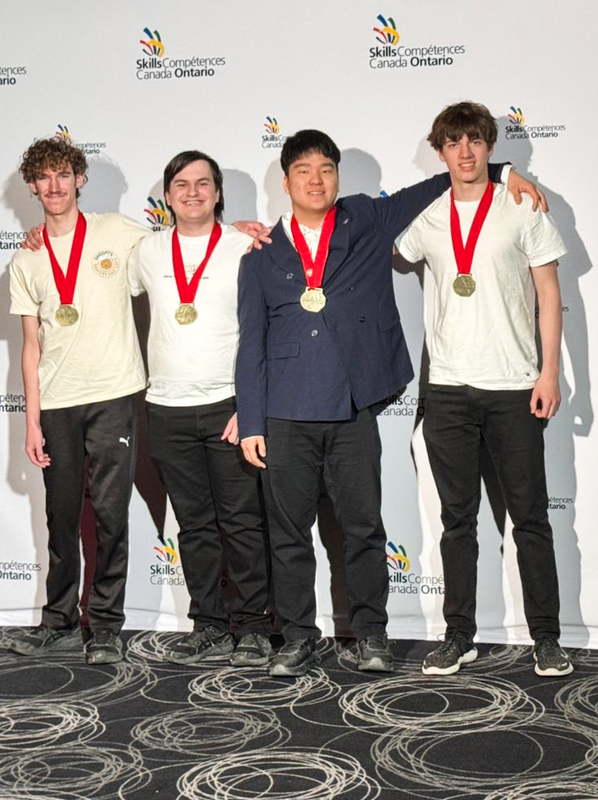 Photo of Owen R. and Alexander C., along with Insung P. and Max M., posing with their medals at the TCDSB Robotics competitions