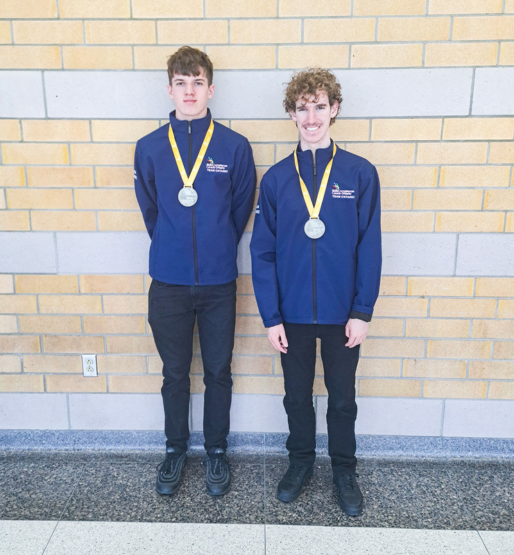 Photo of Owen R. and Alexander C. posing with their medals