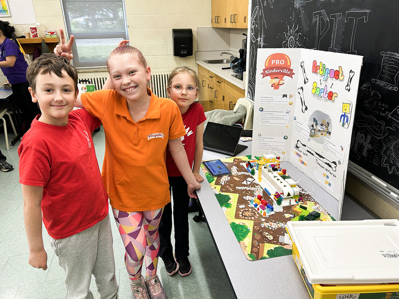 Photo of students exploring a lego exhibit at the festival