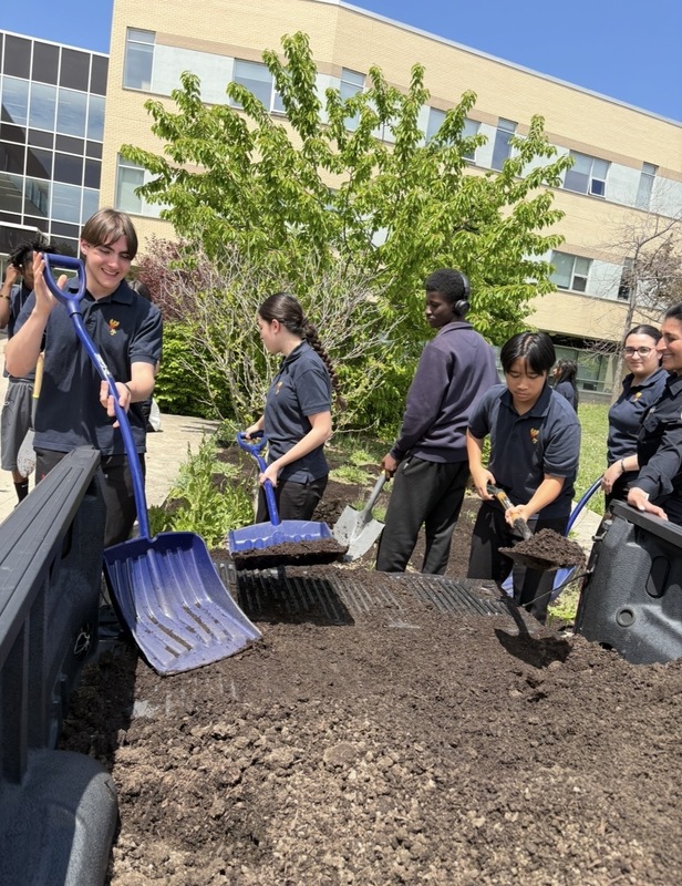 Photo of MPJ students working in the garden