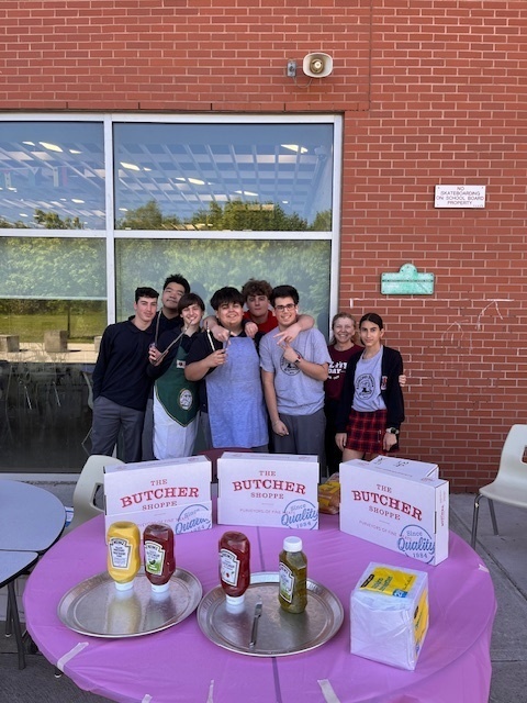 Photo of Redmond students holding the hotdog sale