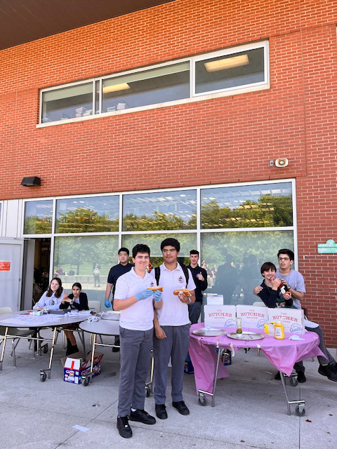 Photo of Redmond students holding the hotdog sale