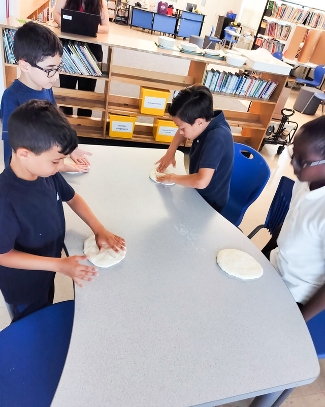 Photo of students making the pizzas