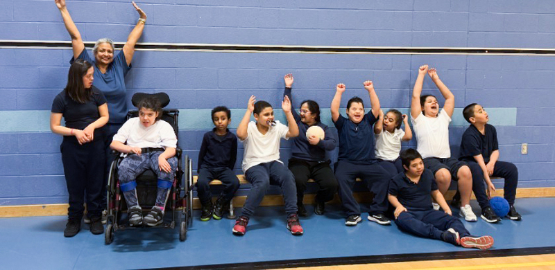 Photo of Ms. Devine together with her students