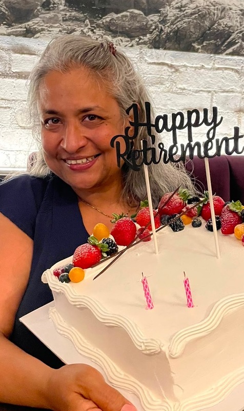Photo of Ms. Devine with her retirement cake