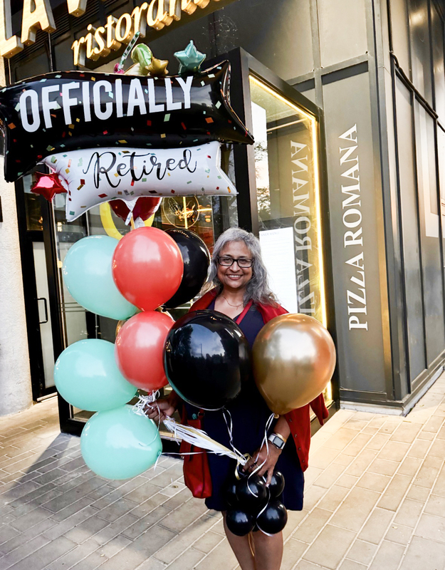Photo of Ms. Devine with retirement balloons