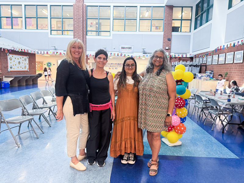 Photo of Ms. Devine and fellow staff at the celebration