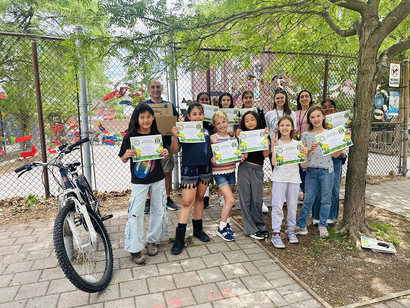 Group photo of St. Cecilia students and staff with the achievement certificates