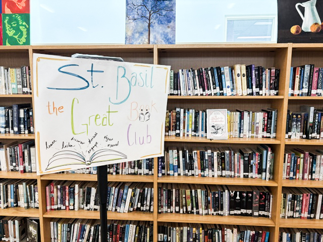 Photo of the St. Basil-the-Great library with the book club sign on a stand