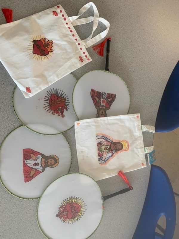 Photo of fans and totebags with images of Jesus made by the students as keepsakes