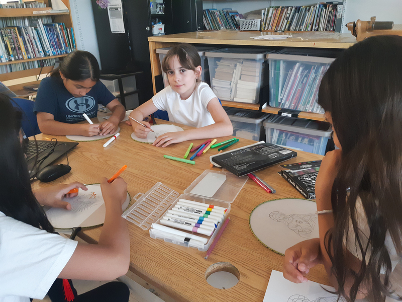 Photo of students working on their keepsakes together