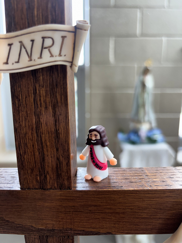 Photo of a mini figurine of Jesus perched on a cross