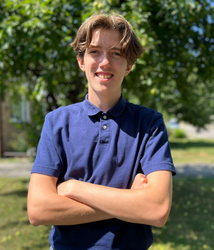 Photo of Antonio standing in his blue school uniform