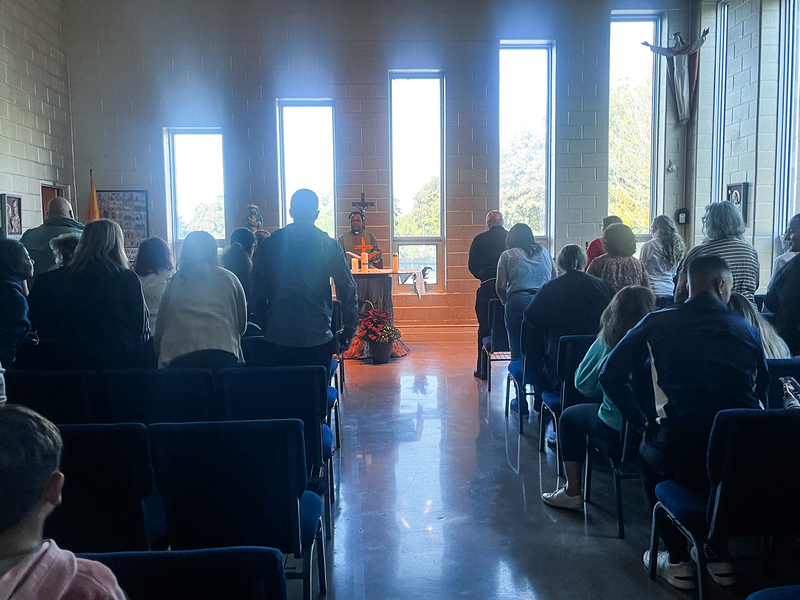 Photo of Father Joseph speaking to the Loretto College staff