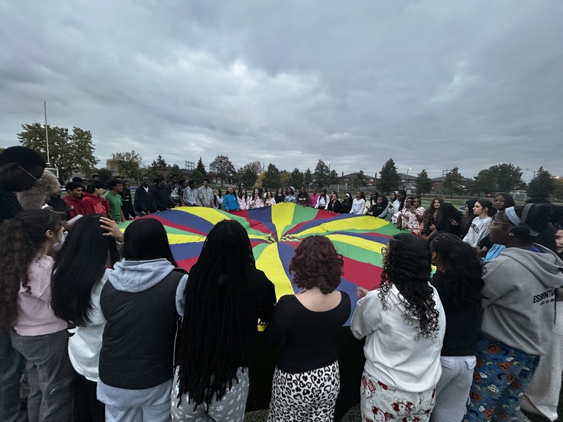 Father Henry Carr Grade 12 students gather together at sunrise