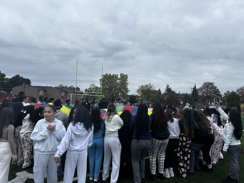 Father Henry Carr Grade 12 students gather together at sunrise