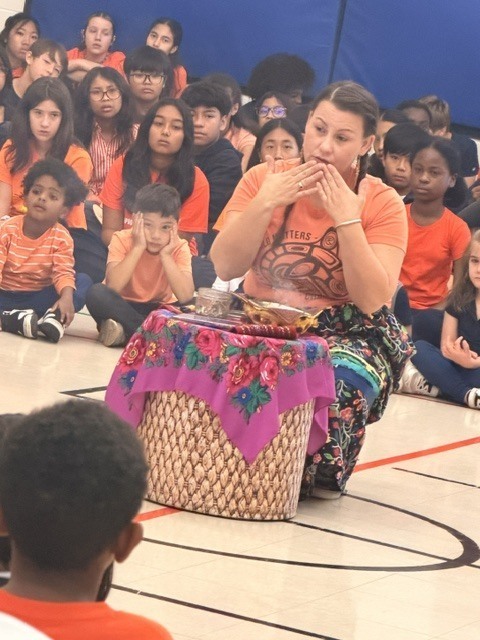 Photo of OLW students witnessing the smudging ceremony at the assemblya