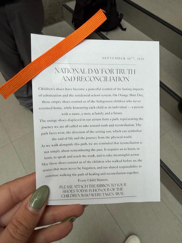 Hand holding a printed certificate titled “National Day for Truth and Reconciliation,” dated September 30, 2024, with an orange ribbon across the top and green nail polish visible.