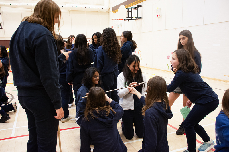 Photo of students doing science activities together in the school gym