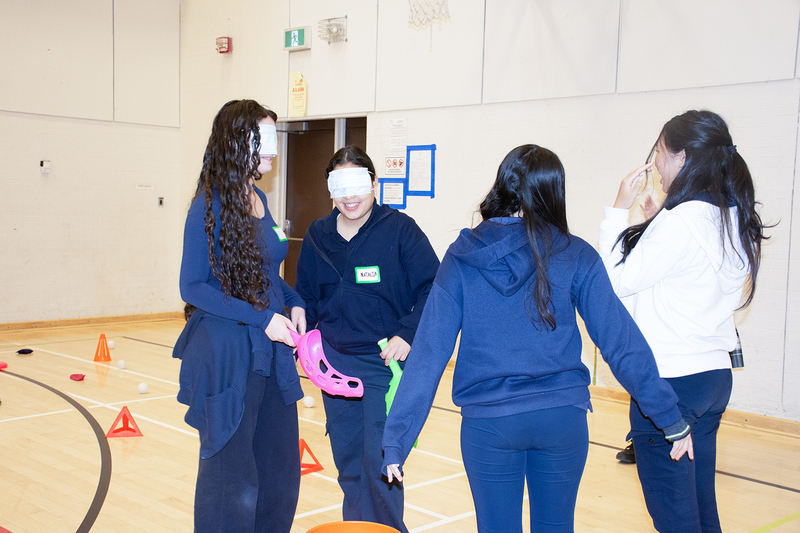 Photo of students doing science activities together in the school gym