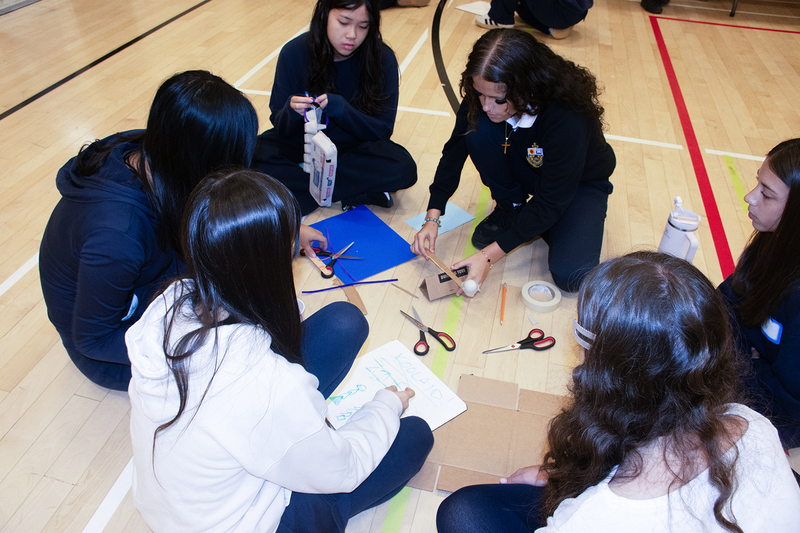Photo of students doing science activities together in the school gym