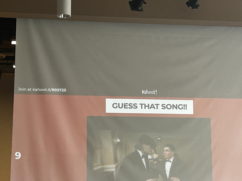 Photo of a closeup of the projector showing the screen of a Kahoot guess that song game