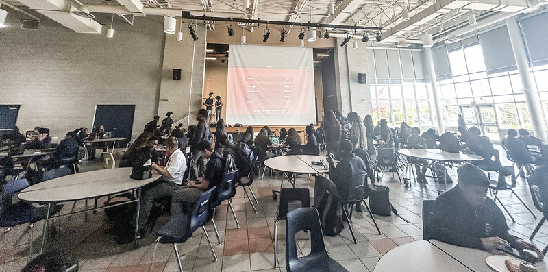 Photo of Father Henry Carr students enjoying their lunch period with a Kahoot game on the projector screen