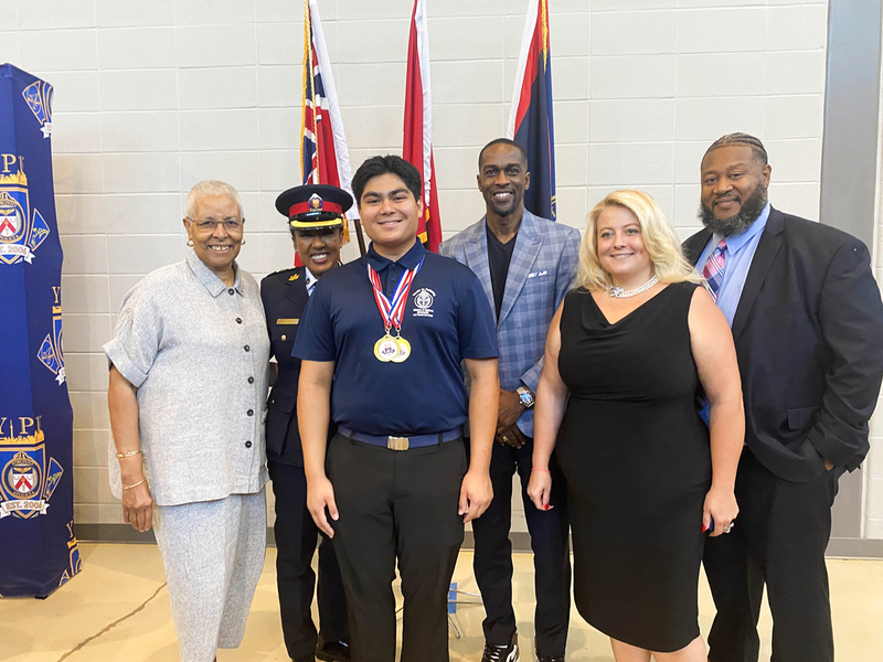 Photo of Anthony with his medals, along with Dr. Mary Ann Chambers, Toronto Police Chief Superintendent Kelly Skinner, representatives of the Jamaican Consulate, and the parliamentary assistant to MPP Lorne Coe.