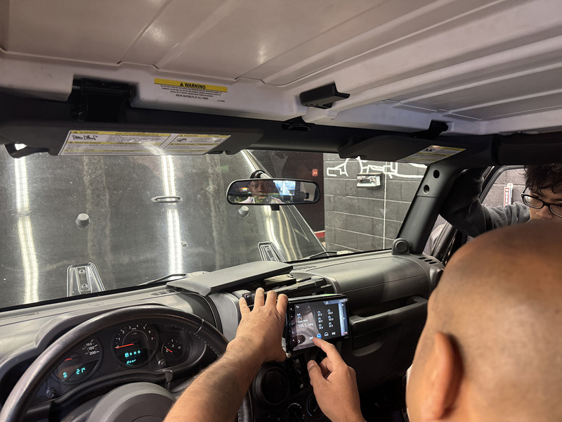 Photo of Sidd in a car being serviced