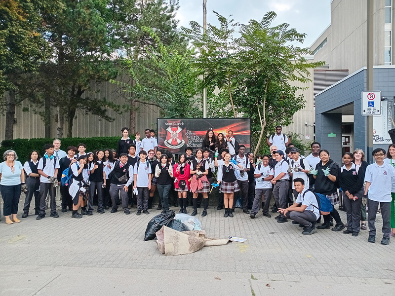 Group photo of St. Patrick students and staff after the cleanup with the bags they filled