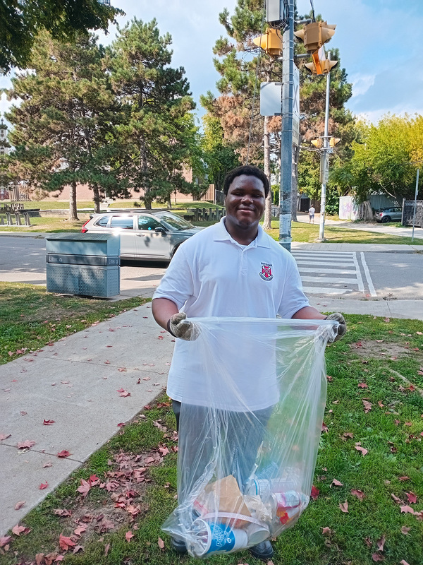 Photo of a St. Patrick student doing clean up
