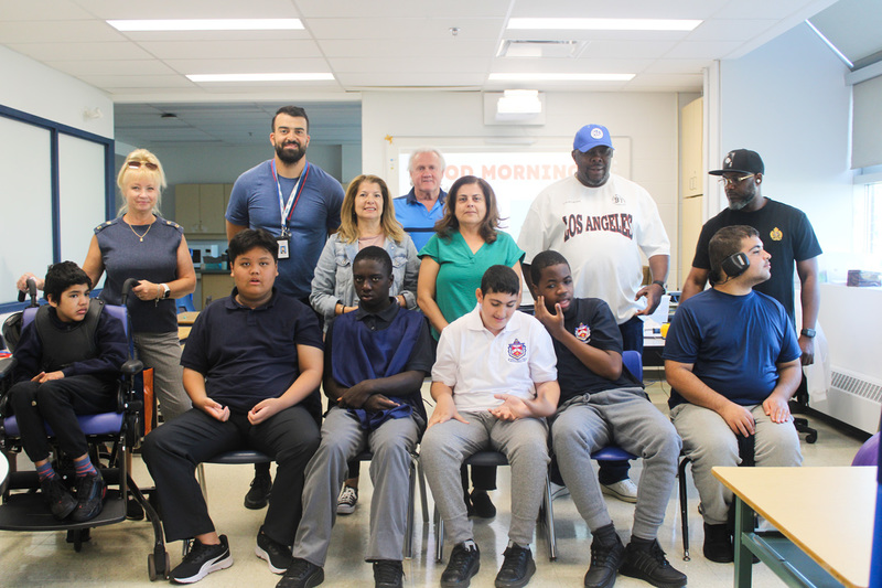 Group photo of Father Henry Carr ISP students and staff in a newly renovated classroom